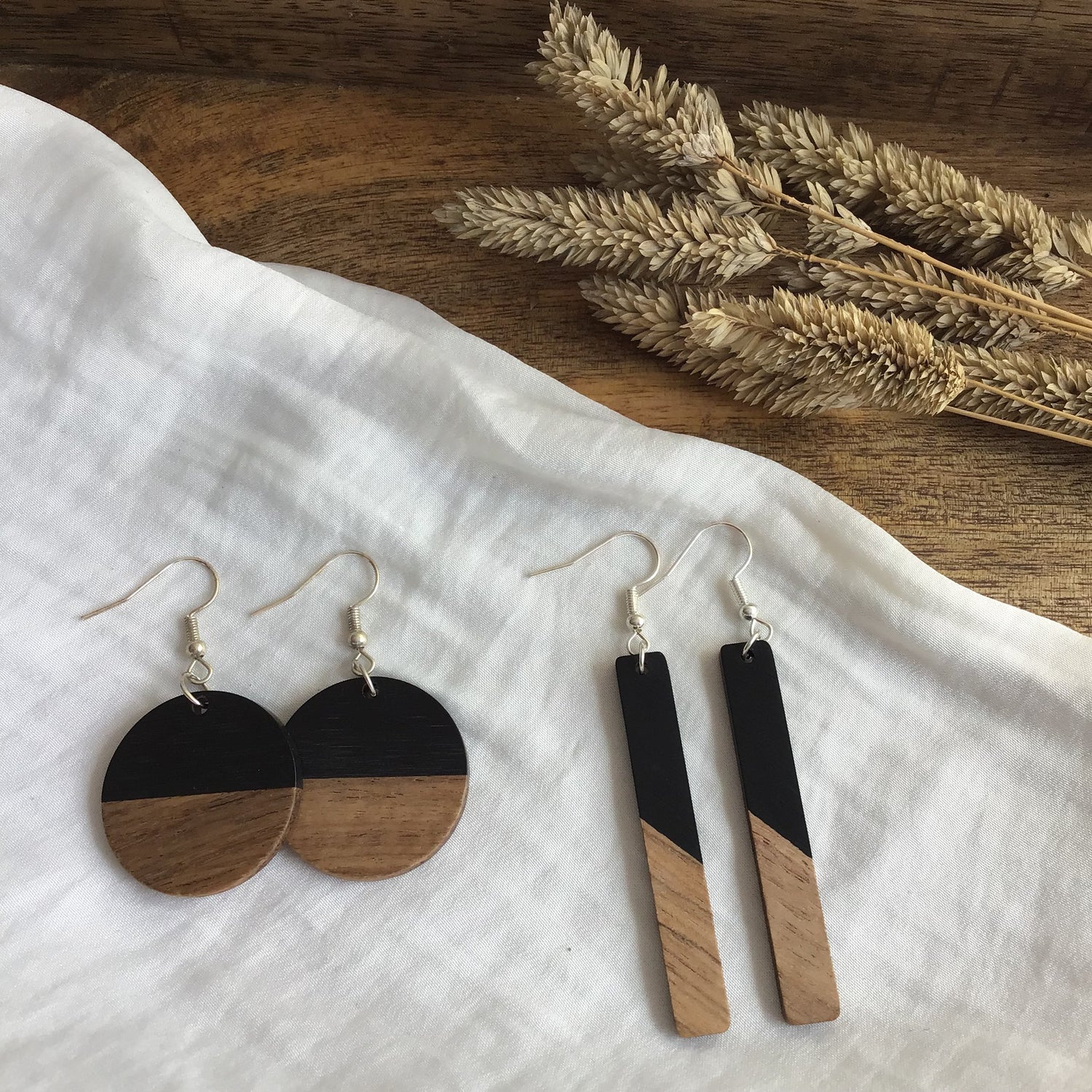 Two style of Fall for Fancy wood and resin earrings one round and one long and slender. 