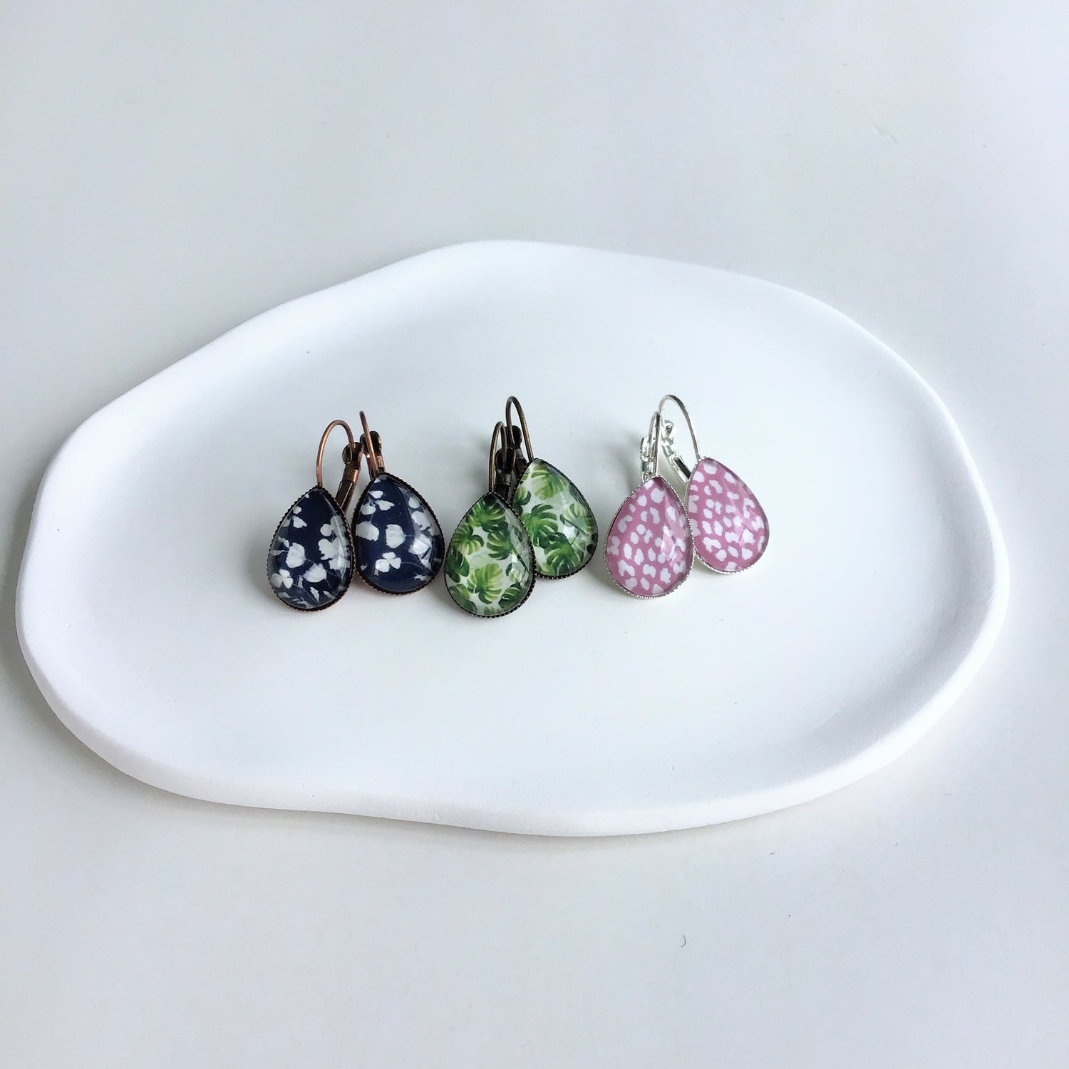 Tear drop glass dome earring in a pink animal print