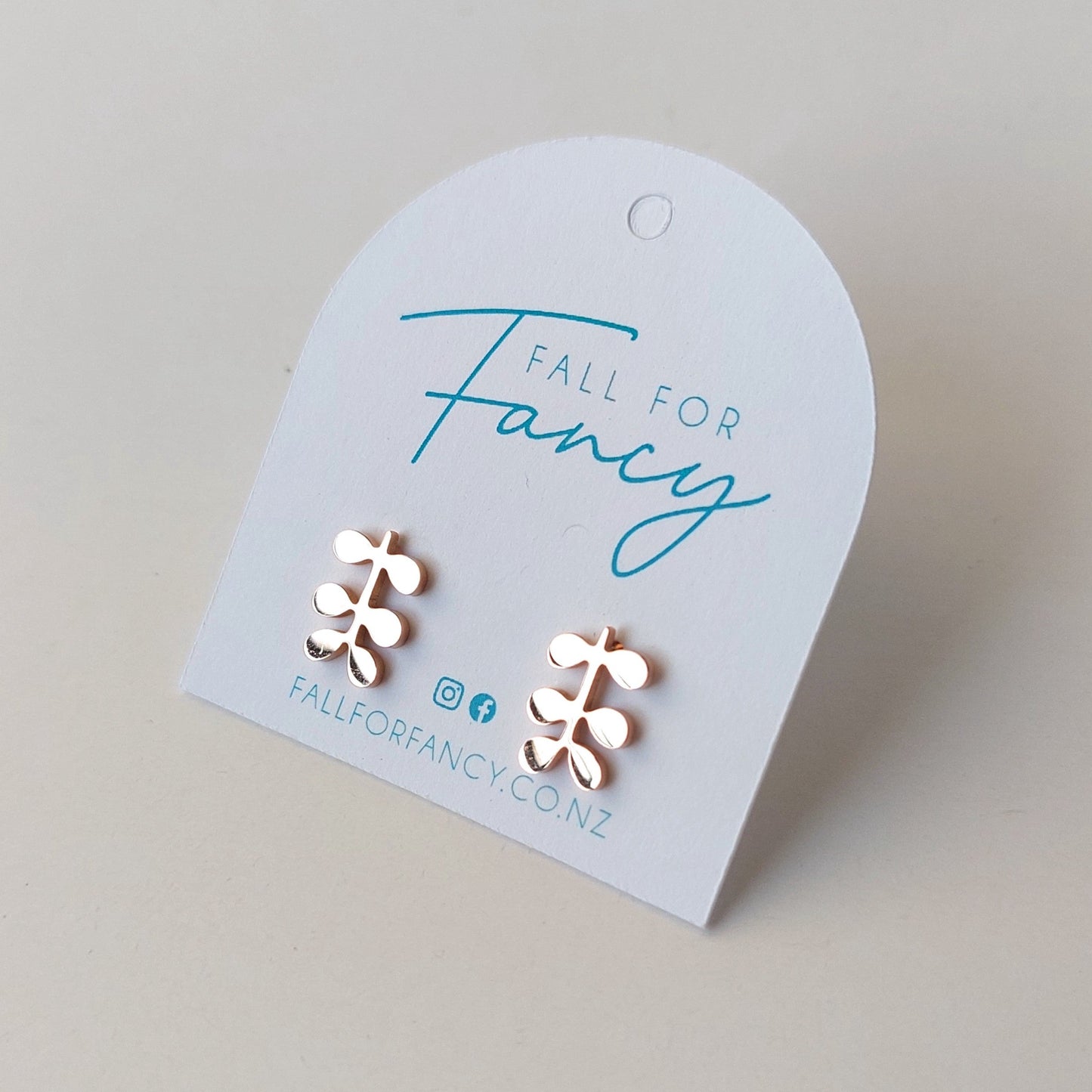 Small rose gold stainless steel studs each earring has 6 small leaves off a main stem